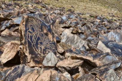 Rocks with ancient pictograms engraved on Saimaluu Tash site in Kyrgyzstan